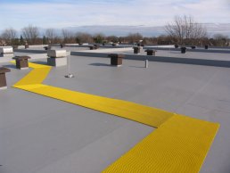 Slip-resistant walkways on smooth flat roofs